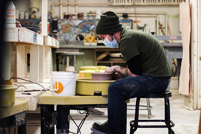Mac Star McCusker throws a piece at a wheel in Union Project's ceramics studio