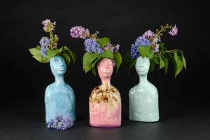 Three colorful ceramic form vases shaped with human characteristics, by Janet Watkins.